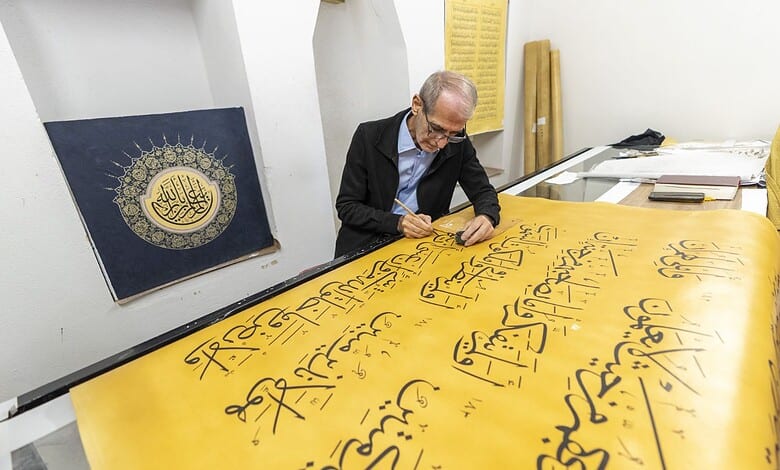 Iraqi Calligrapher Ali Zaman works on the hand written Quran