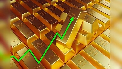 Image shows Stacks of gold bars with a rising green arrow symbolizing an increase in gold prices or market value.