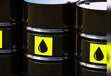 Image shows Black oil barrels with yellow labels featuring a droplet icon arranged in a group.
