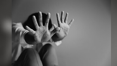 Image showing a child blocking their face with their hands