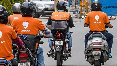 Image showing Swiggy delivery agents on bikes