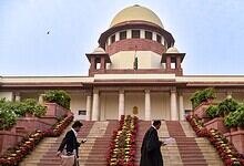 View of the Supreme Court of India with steps and surrounding greenery.
