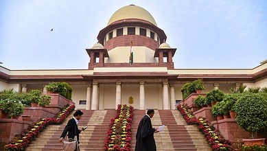 View of the Supreme Court of India with steps and surrounding greenery.