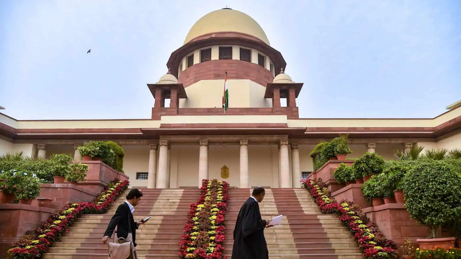 View of the Supreme Court of India with steps and surrounding greenery.