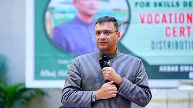 Akbaruddin Owaisi speaking at an event, comparing Revanth Reddy to Yogi Adityanath over demolition remark.