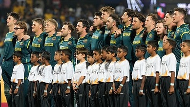 Australian cricket team standing together during a game.