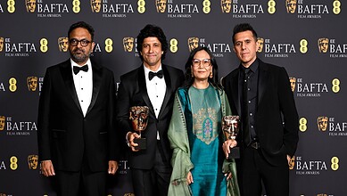 Film award ceremony with cast members celebrating BAFTA win for 'Boong' in London.
