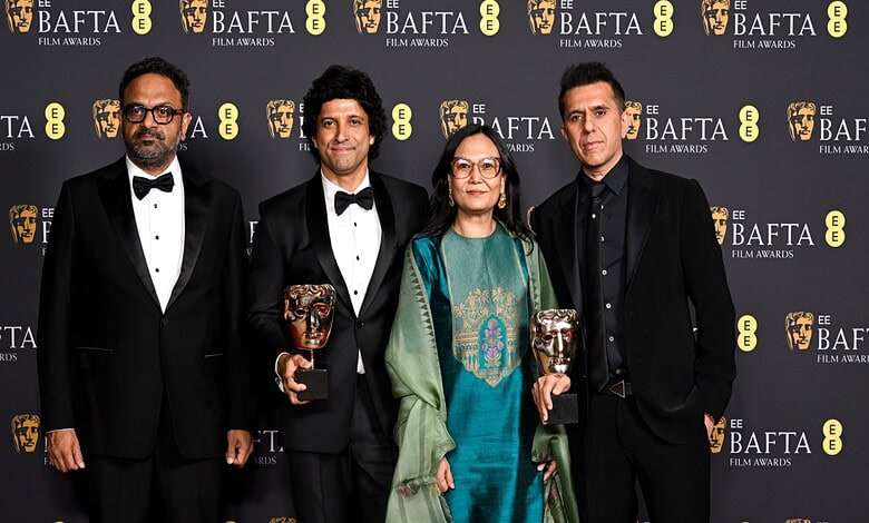 Film award ceremony with cast members celebrating BAFTA win for 'Boong' in London.