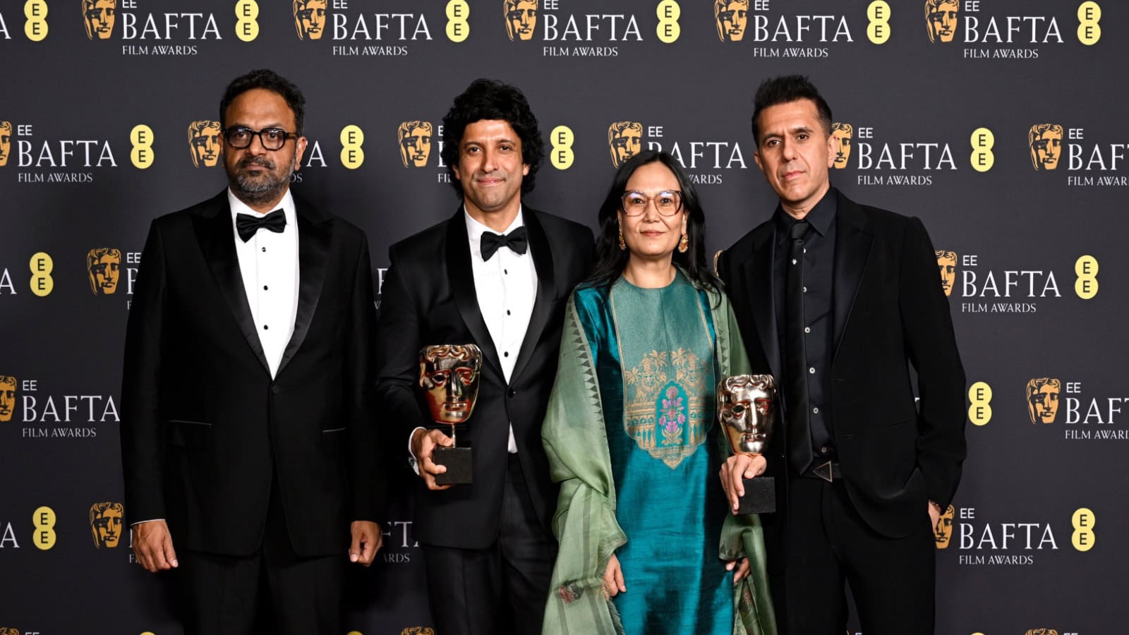 Film award ceremony with cast members celebrating BAFTA win for 'Boong' in London.