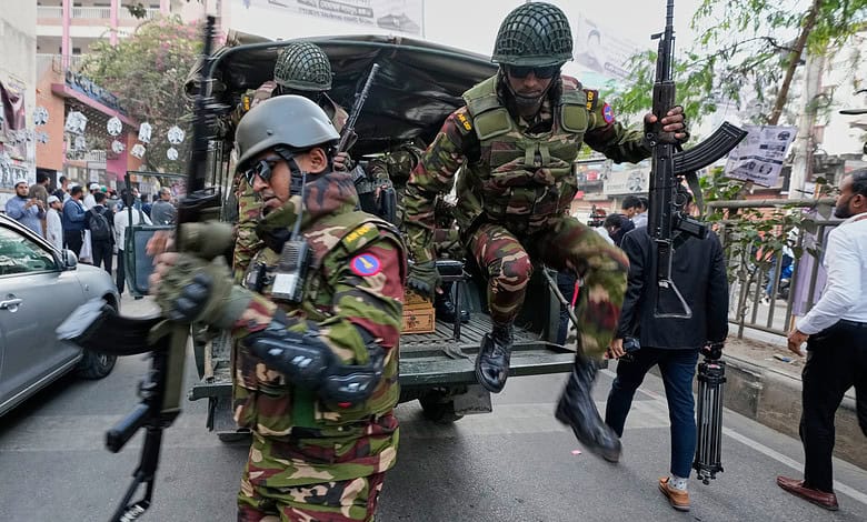 Armed soldiers at polling station during Bangladesh elections, violence reported.