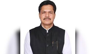 Political leader speaking at a public event in India.