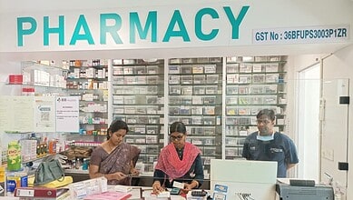 Pharmacy interior with staff assisting customers in a well-stocked drugstore.