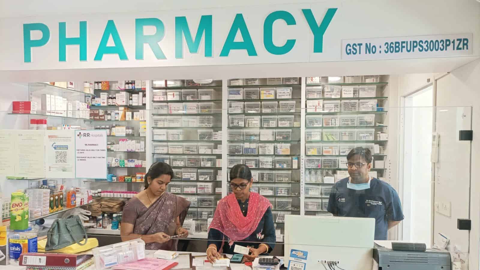 Pharmacy interior with staff assisting customers in a well-stocked drugstore.