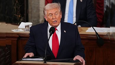 Donald Trump speaking at the State of the Union address, emphasizing US achievements.