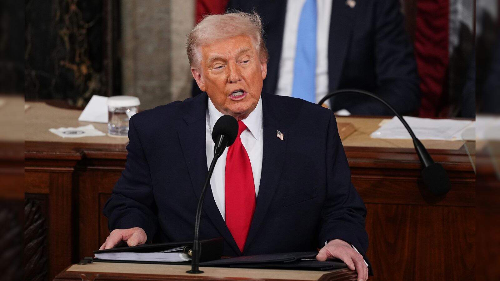 Donald Trump speaking at the State of the Union address, emphasizing US achievements.