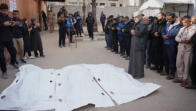 Palestinians mourn over the bodies of men who were killed in an Israeli military strike, during their funeral at Nasser hospital in Khan Younis, Feb 4, 2026.