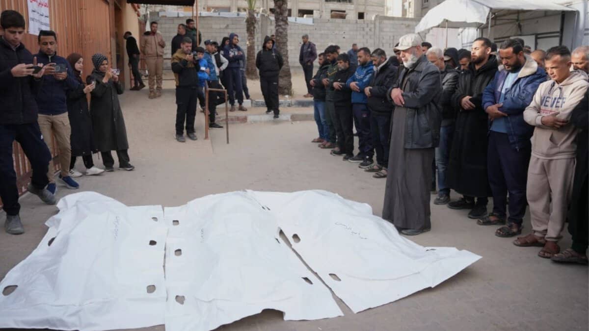 Palestinians mourn over the bodies of men who were killed in an Israeli military strike, during their funeral at Nasser hospital in Khan Younis, Feb 4, 2026.