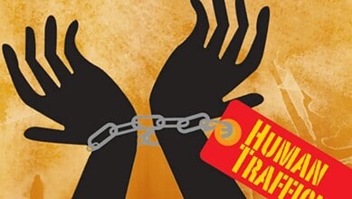Human trafficking awareness illustration with chained hands and warning tag.