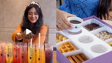 Young woman enjoying Korean dessert with colourful drinks and snacks.