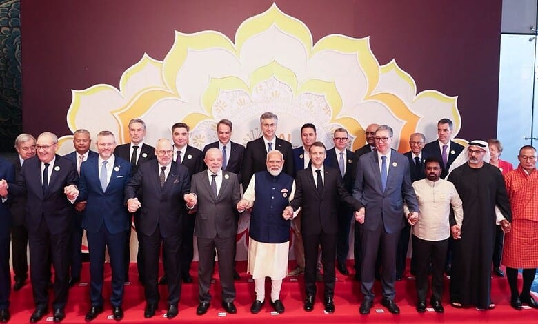 Group of international leaders and officials at the AI Impact Summit signing declaration, promoting globa.