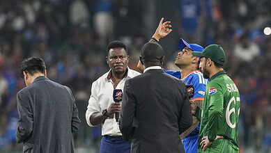 India's captain Suryakumar Yadav flips the coin as Pakistan's captain Salman Agha takes the call during the toss before an ICC Men's T20 World Cup 2026 cricket match between India and Pakistan,