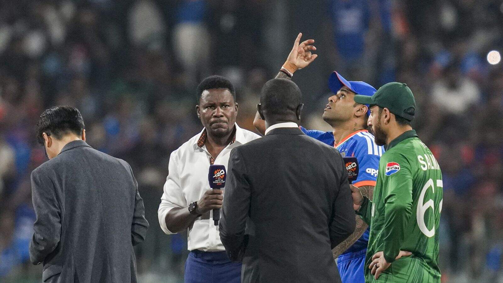 India's captain Suryakumar Yadav flips the coin as Pakistan's captain Salman Agha takes the call during the toss before an ICC Men's T20 World Cup 2026 cricket match between India and Pakistan,