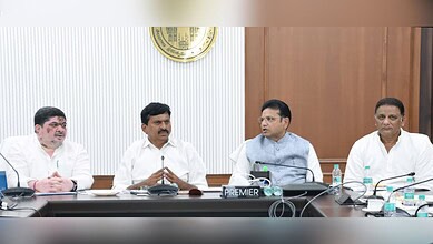 Officials seated at a conference table during a formal meeting.