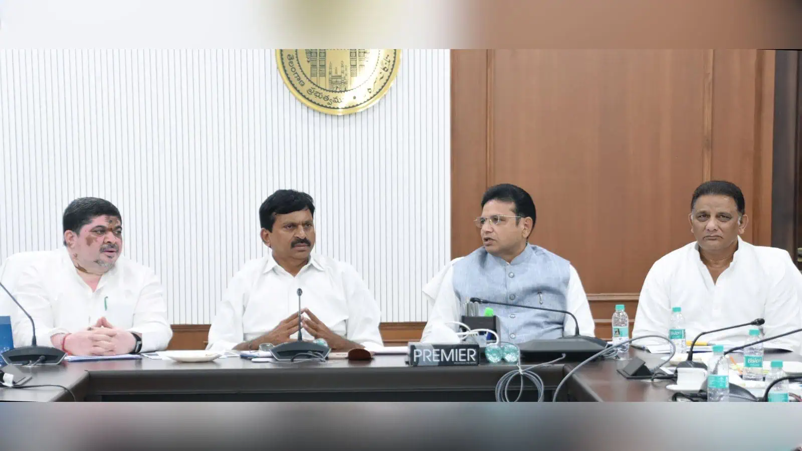 Officials seated at a conference table during a formal meeting.