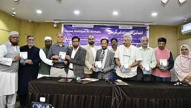 A group of diverse individuals holding books during a book launch event on inner healing.