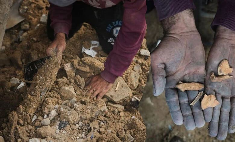 Father's hands digging through debris for remains in Gaza.
