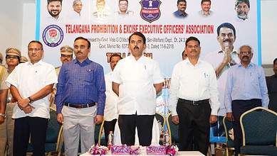 Officials at Telangana Prohibition & Excise event discussing arms provision for excise officers.
