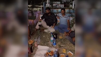 Celebrating with friends outdoors at night, enjoying drinks and snacks in a relaxed setting.