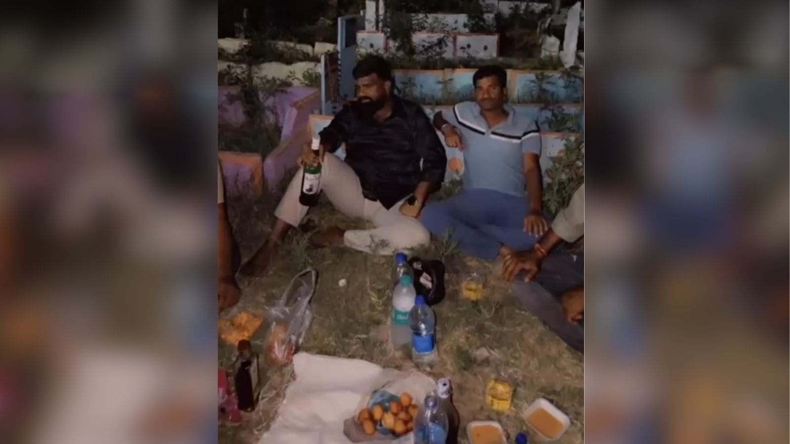 Celebrating with friends outdoors at night, enjoying drinks and snacks in a relaxed setting.