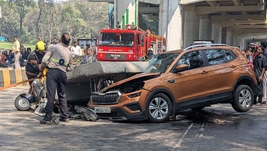 Accident scene with damaged car and emergency responders in Mumbai.