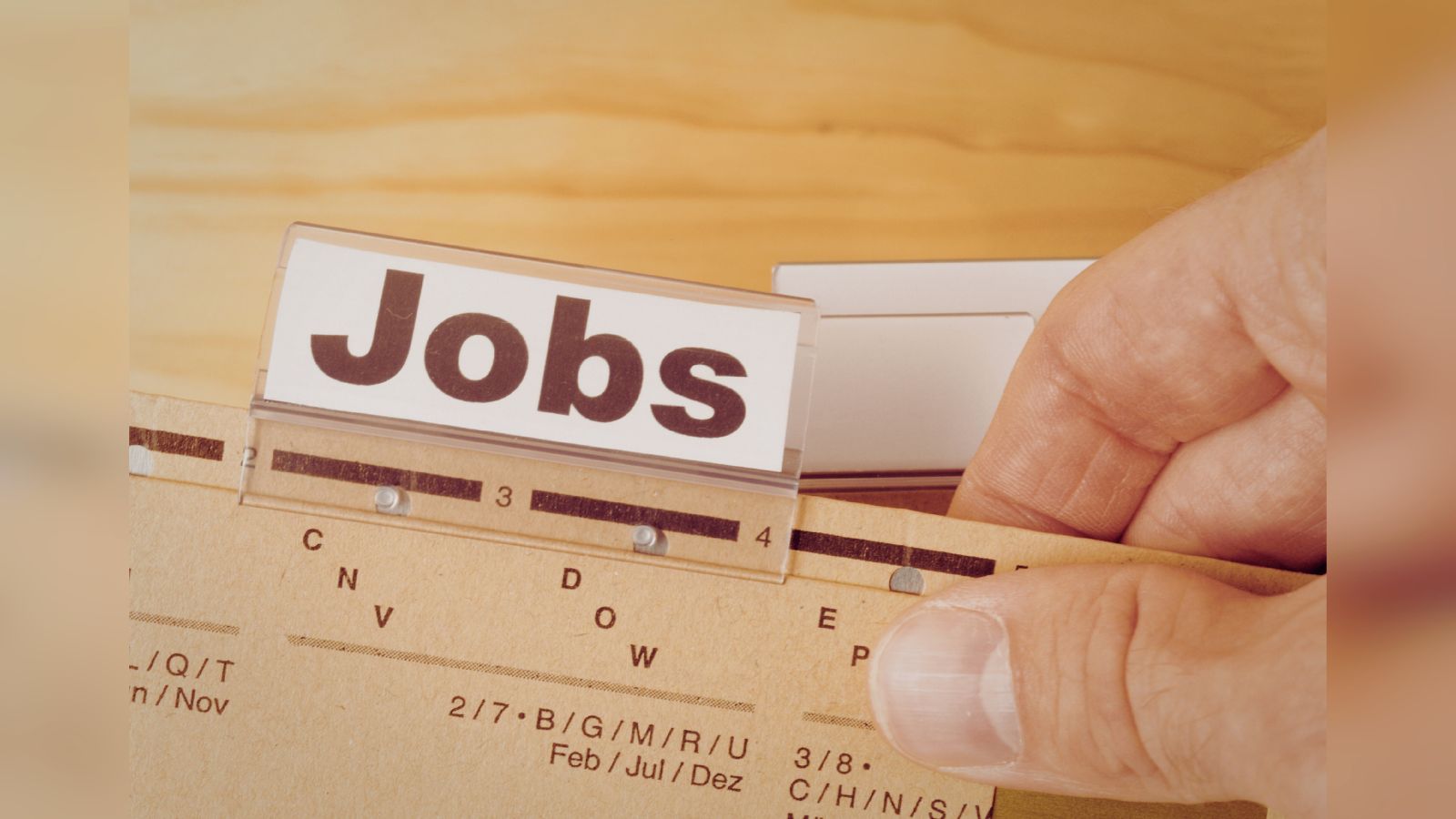 Hand holding a wooden ruler with