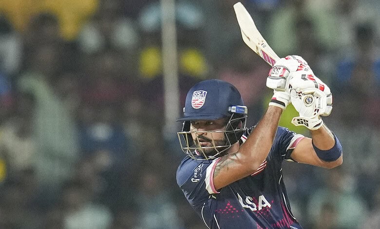 Cricket player in USA team batting at T20 World Cup match.