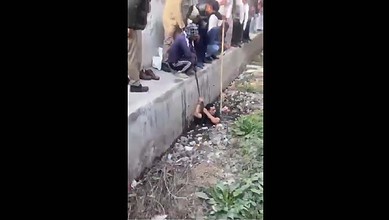 Municipal workers clean drain in UP