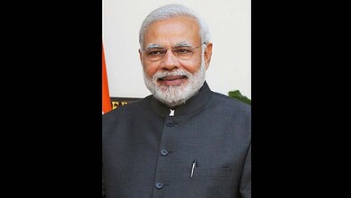 Indian Prime Minister Narendra Modi smiling at the Seva Teerth event.