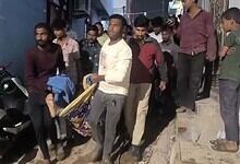 People gather at the site of a house collapse in Hyderabad, with four injured victims receiving assi.