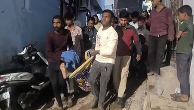 People gather at the site of a house collapse in Hyderabad, with four injured victims receiving assi.
