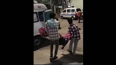 Family members carry dead body of a woman in Telangana after being denied a stretcher
