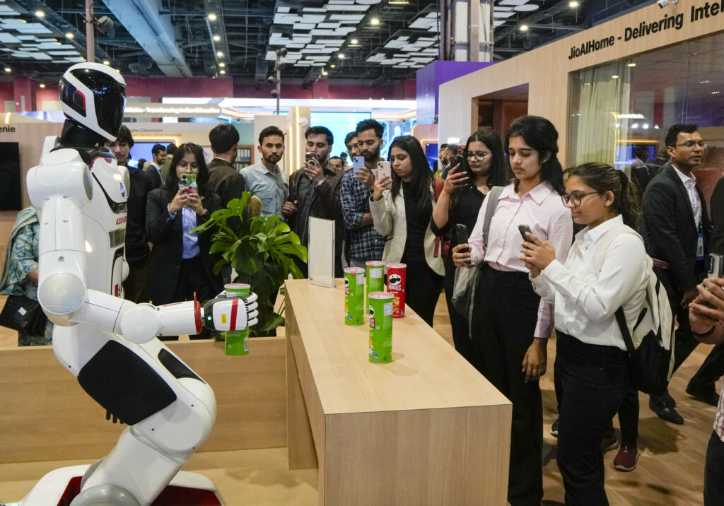 Robotic robot interacts with visitors at the world's largest AI summit in Delhi.