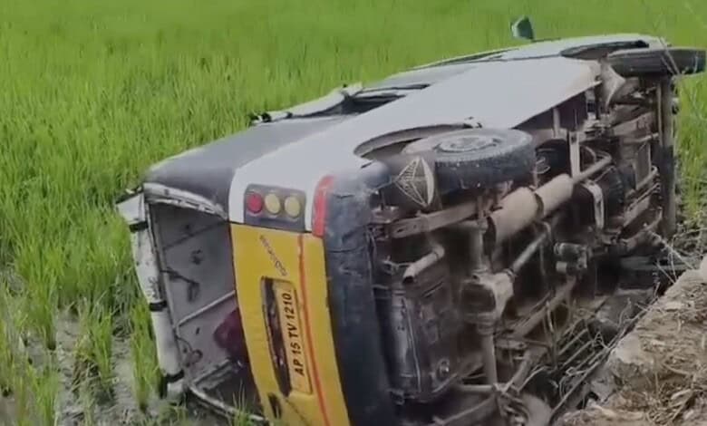 Upside-down bus carrying school students after accident in Telangana, with visible damage and overturned.