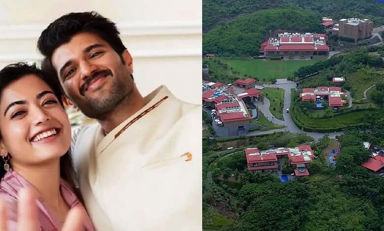 Aerial view of a luxury resort nestled in green hills with multiple buildings and winding roads in India.