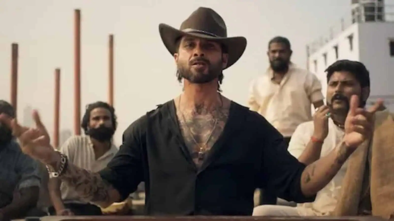 Actor in O'Romeo film speaking to crowd on set.