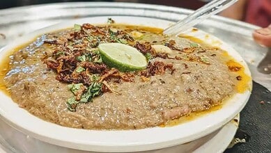 Delicious Hyderabad Haleem with beef, spices, and garnishes, served in a traditional bowl during Ramzan c.