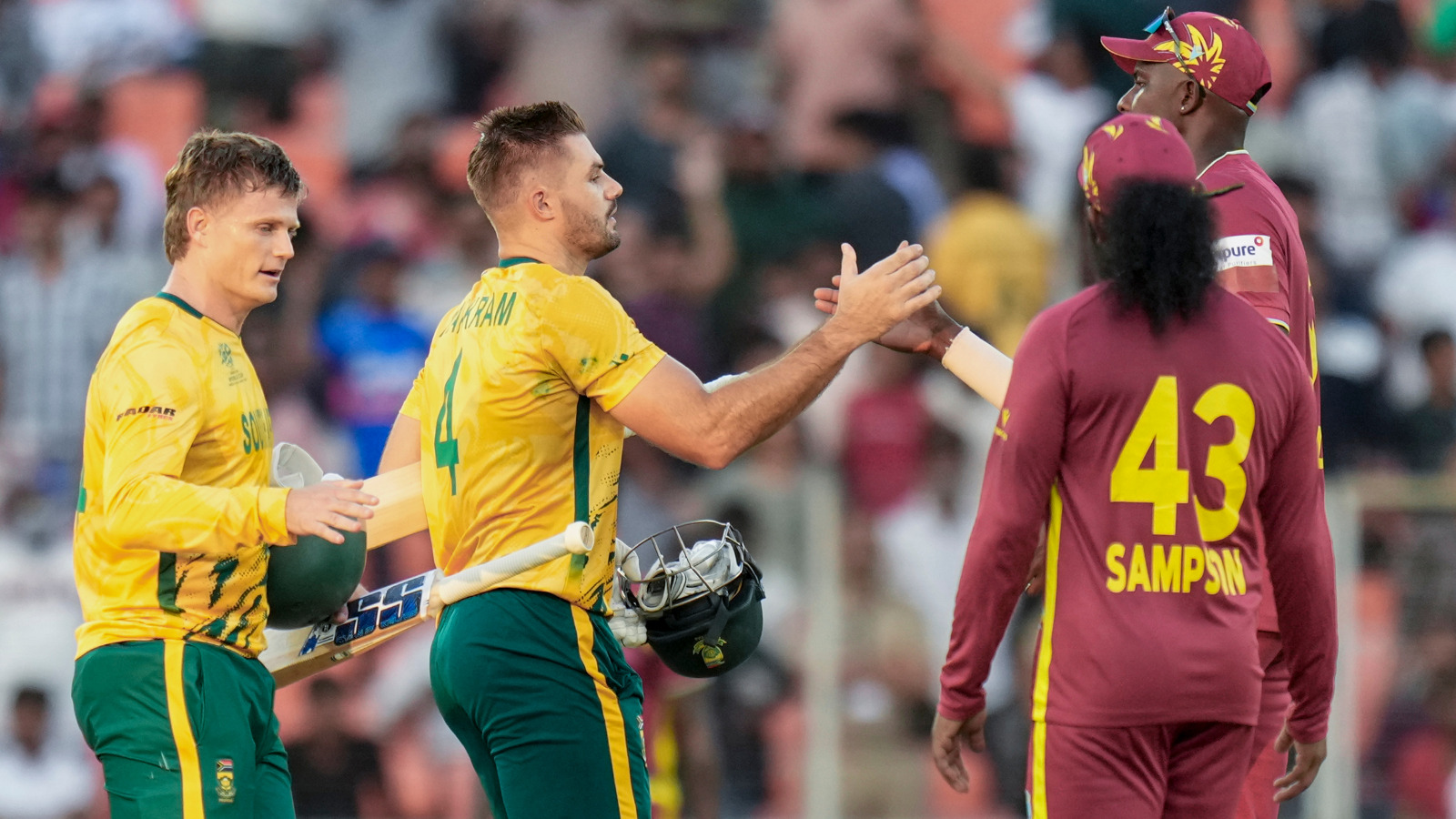 South Africa's captain Aiden Markram, centre, and Ryan Rickelton, left, being greeted by West Indies' players after South Africa won the ICC Men's T20 World Cup 2026 cricket match against West Ind