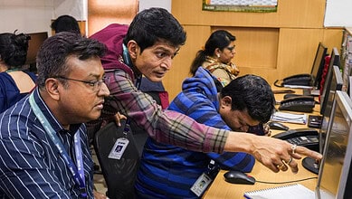Traders react after fluctuations in stock market, in Kolkata, Sunday, Feb. 1, 2026.