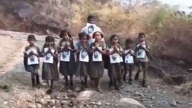 The image shows tribal children holding AP Deputy CM Pawan Kalyan's photo and requesting him to lay a road so that they could go to school in Srungavarapukota mandal of Vizianagaram district in Andhra Pradesh.