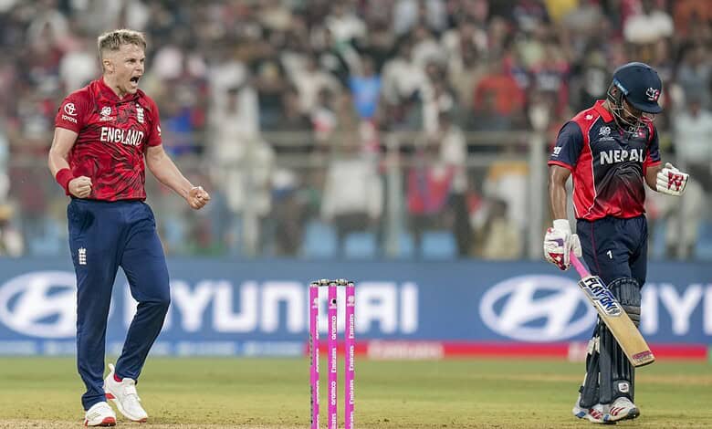 England's Sam Curran, left, celebrates as Nepal's Lokesh Bam, right, looks dejected after the former's team won an ICC Men's T20 World Cup 2026 cricket match between England and Nepal at the Wankhede Stadium, in Mumbai on Sunday. (PTI Photo/Shashank Parade)